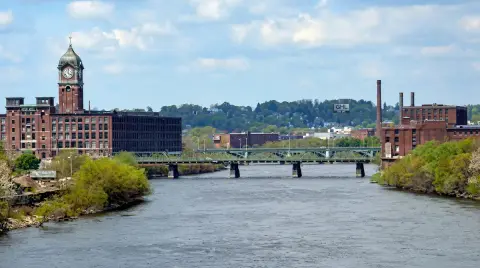 Mill clock tower, bridge and river in Lawrence, Massachusetts.