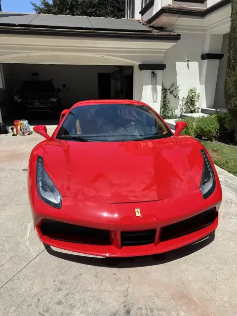 Freshly detailed red Ferrari 488 GTB in an Orange County driveway