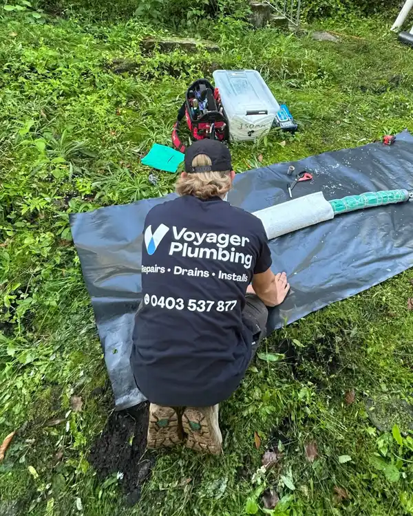 Voyager Plumbing plumber working on a drain job