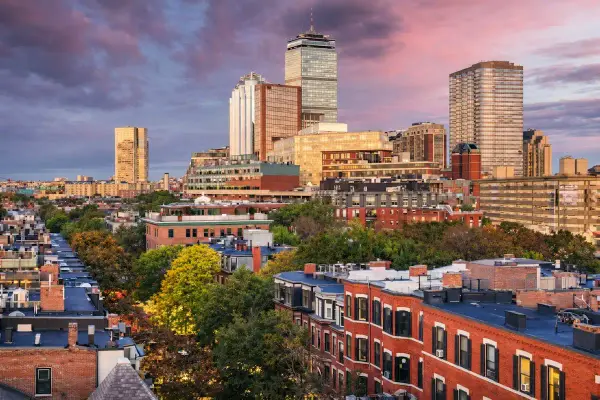 Boston skyline above brick row houses.