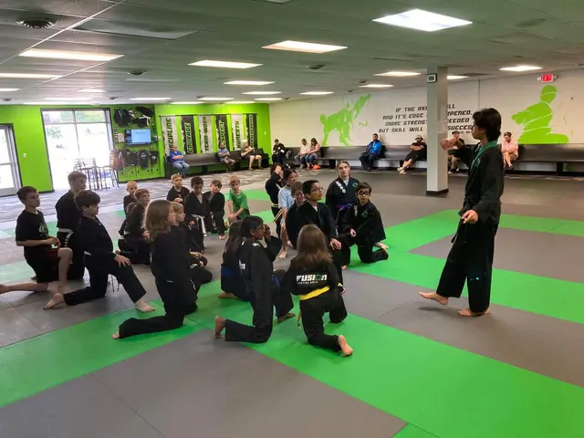 Instructor coaching students during a kids class at Fusion in Bloomington, IL
