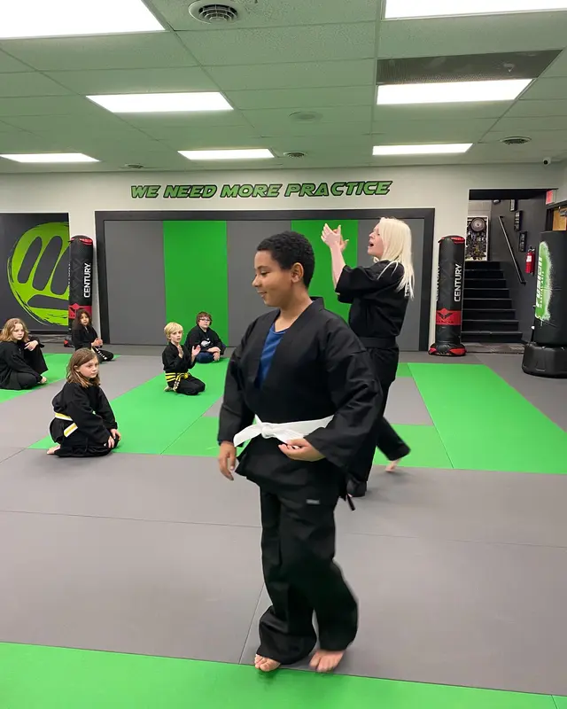Student demonstrating techniques during belt testing at Fusion