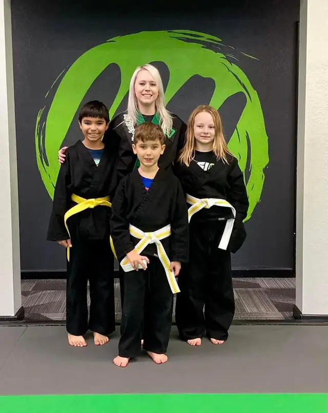 Young students at a belt promotion at Fusion Martial Arts