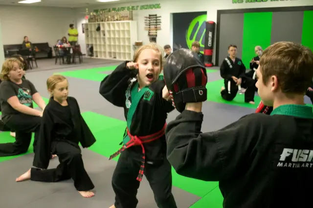 Kids partner pad drill at Fusion Martial Arts