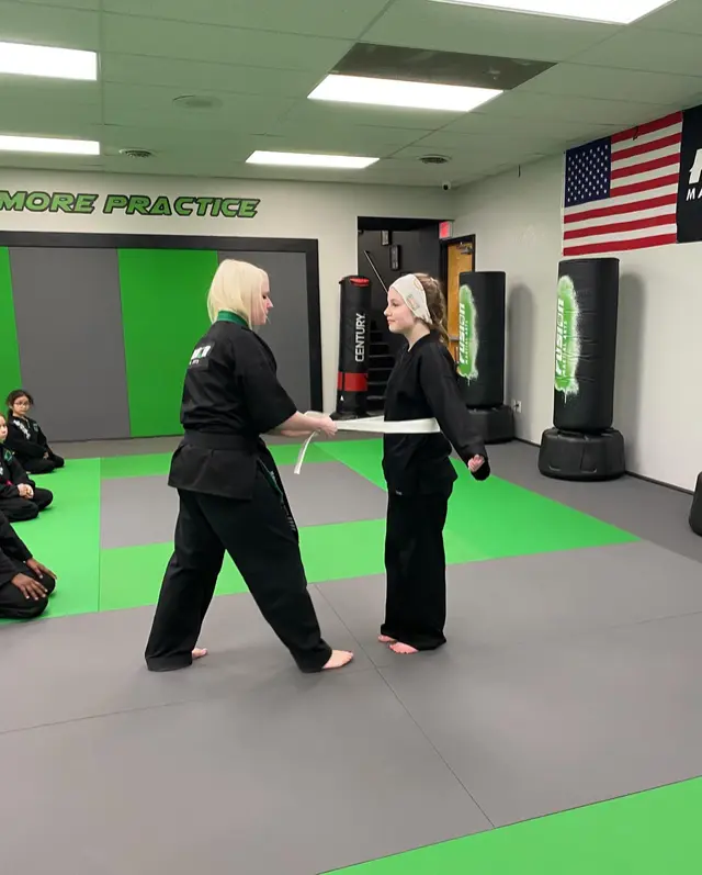 Student demonstrating skills during belt testing at Fusion