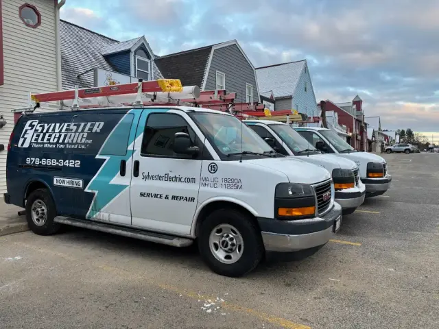 Sylvester Electric service vans parked outside residential buildings