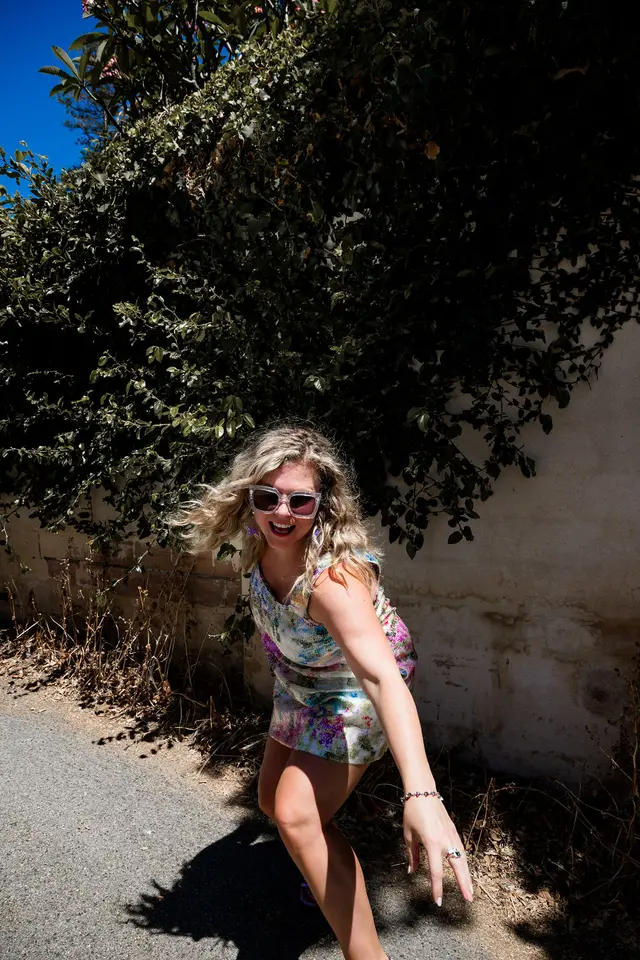 Zoë Condon, digital strategist and founder of Z List Media, laughing in sunglasses on a sunny laneway in South West WA