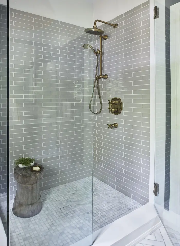 Marble tiled walk in shower with a glass enclosure
