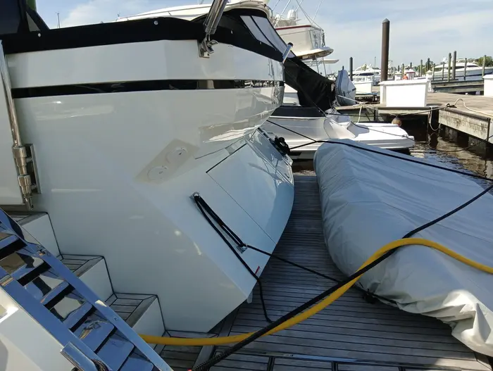 Swim platform and tender during a wash, hose on deck
