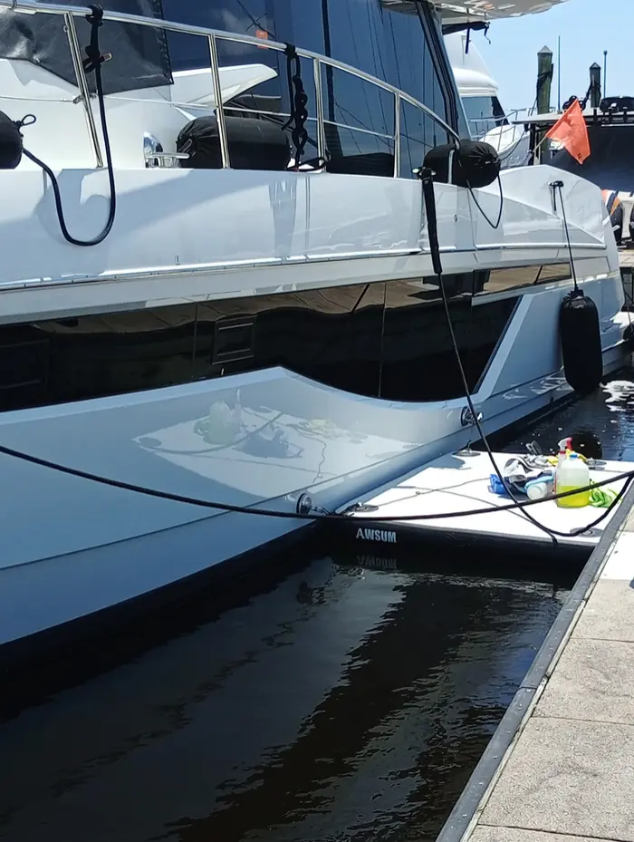 Yacht hull and swim platform with wash gear on the dock