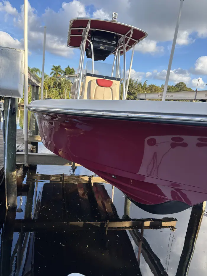 Red center console hull with deep gloss on a boat lift