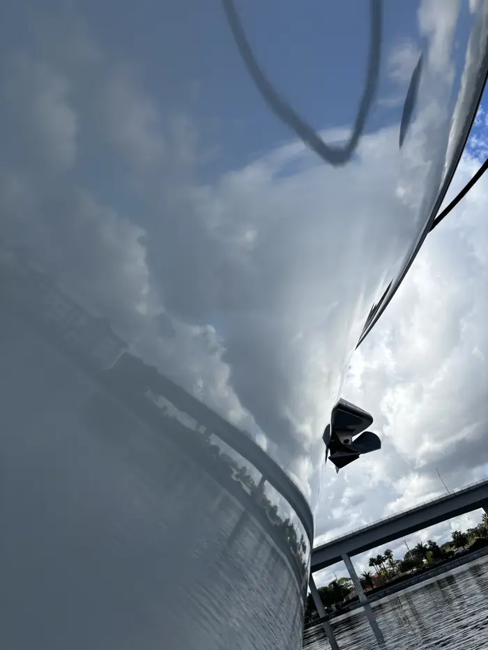 Clouds reflected in a freshly finished white hull