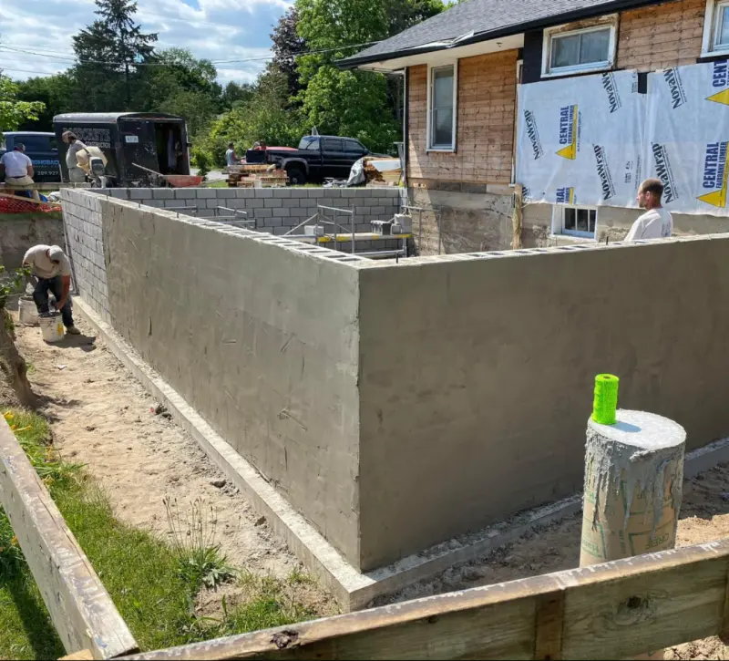 Parged concrete block foundation wall on a new build
