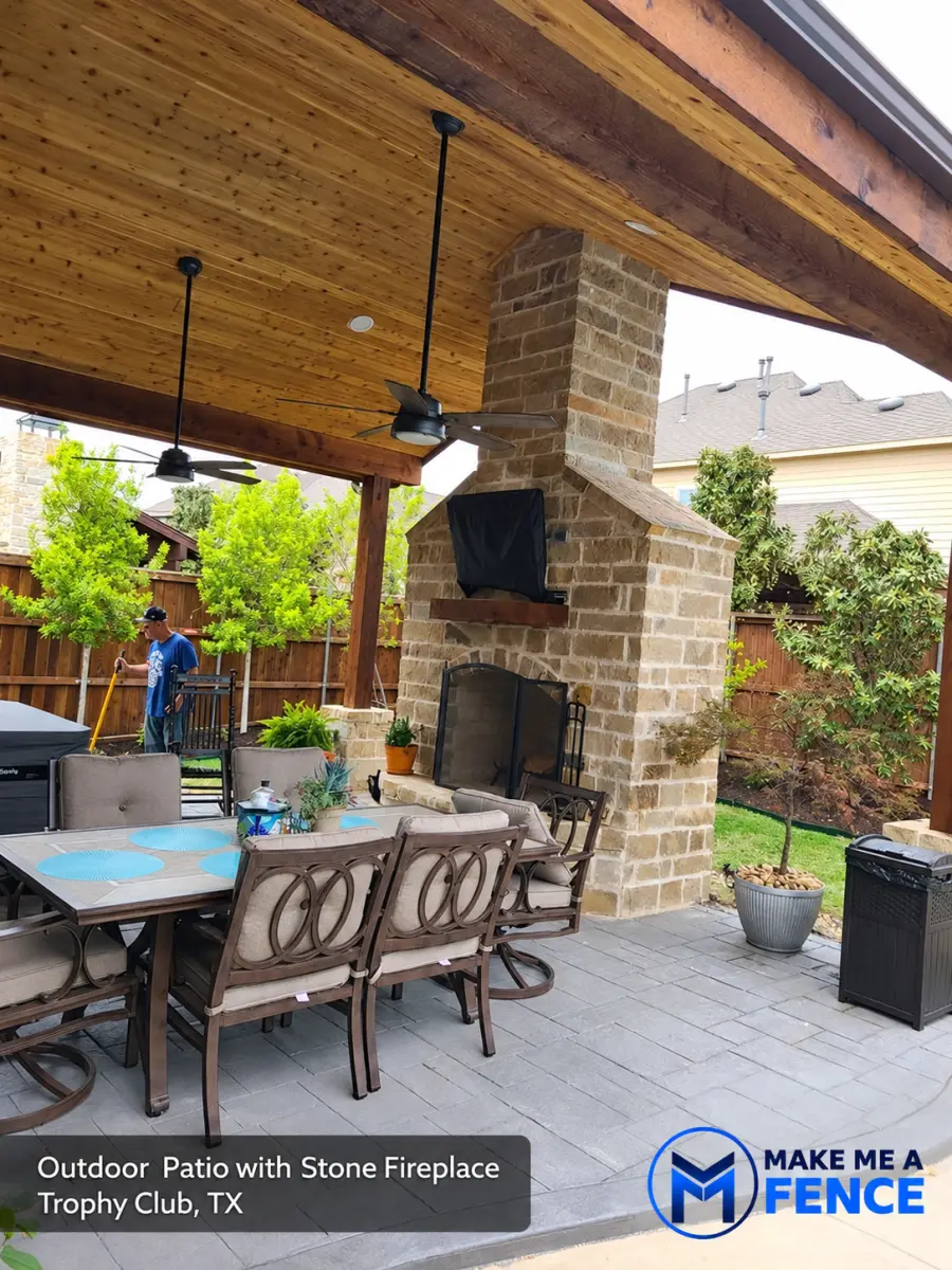 Outdoor patio with stone fireplace installed by Make Me A Fence in Trophy Club, Texas
