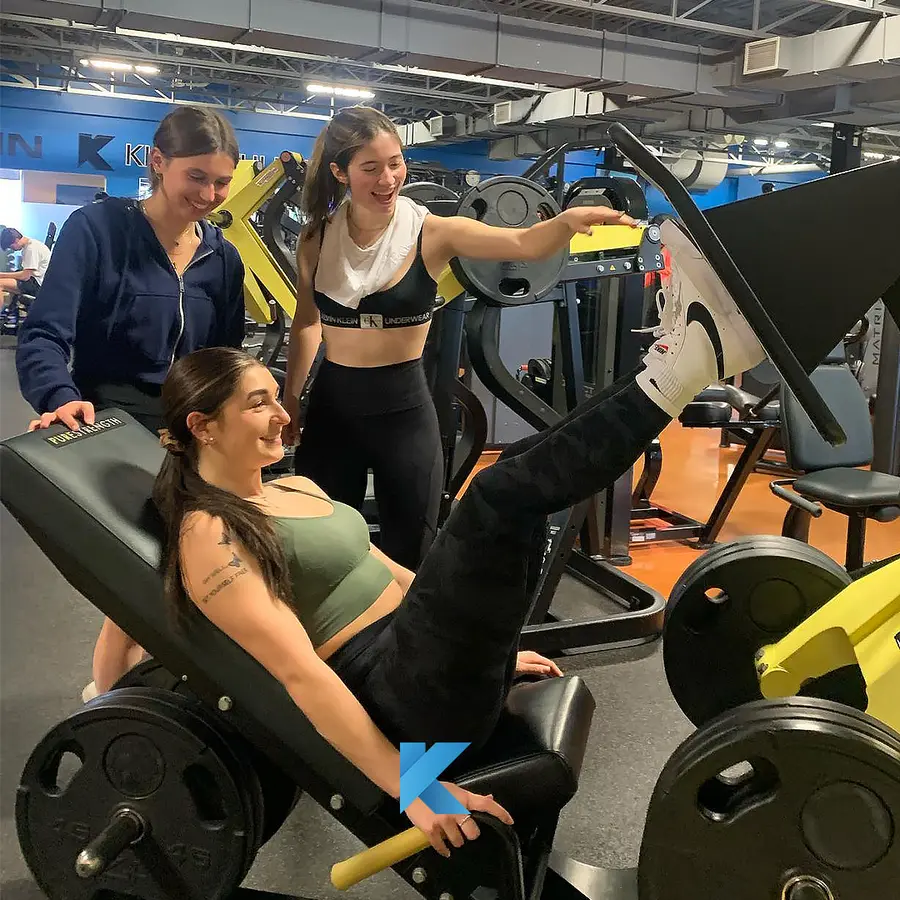 Three members training together on the leg press