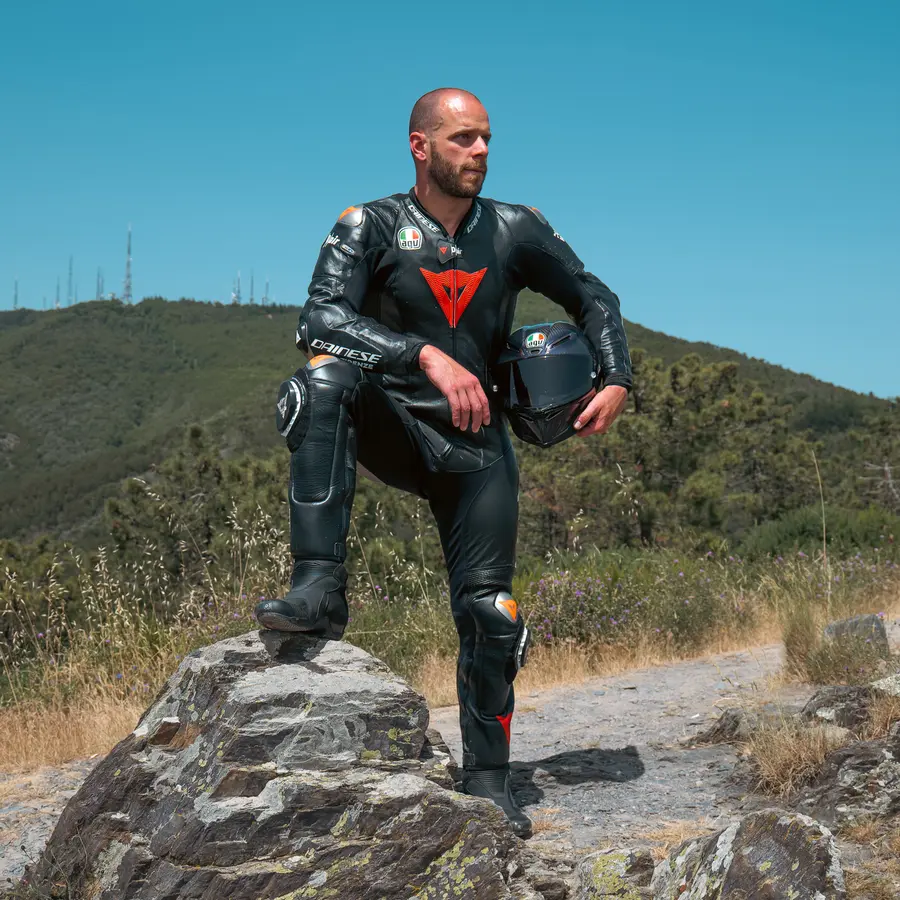 Federico Pieri in tuta da moto con il casco in mano