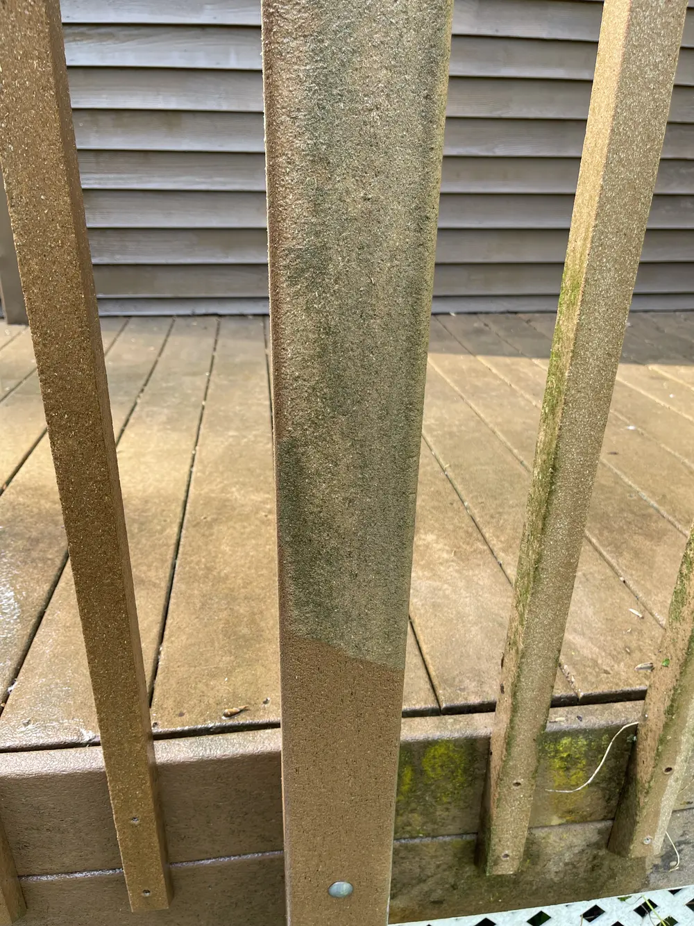 Deck railing half-washed, showing the clean line