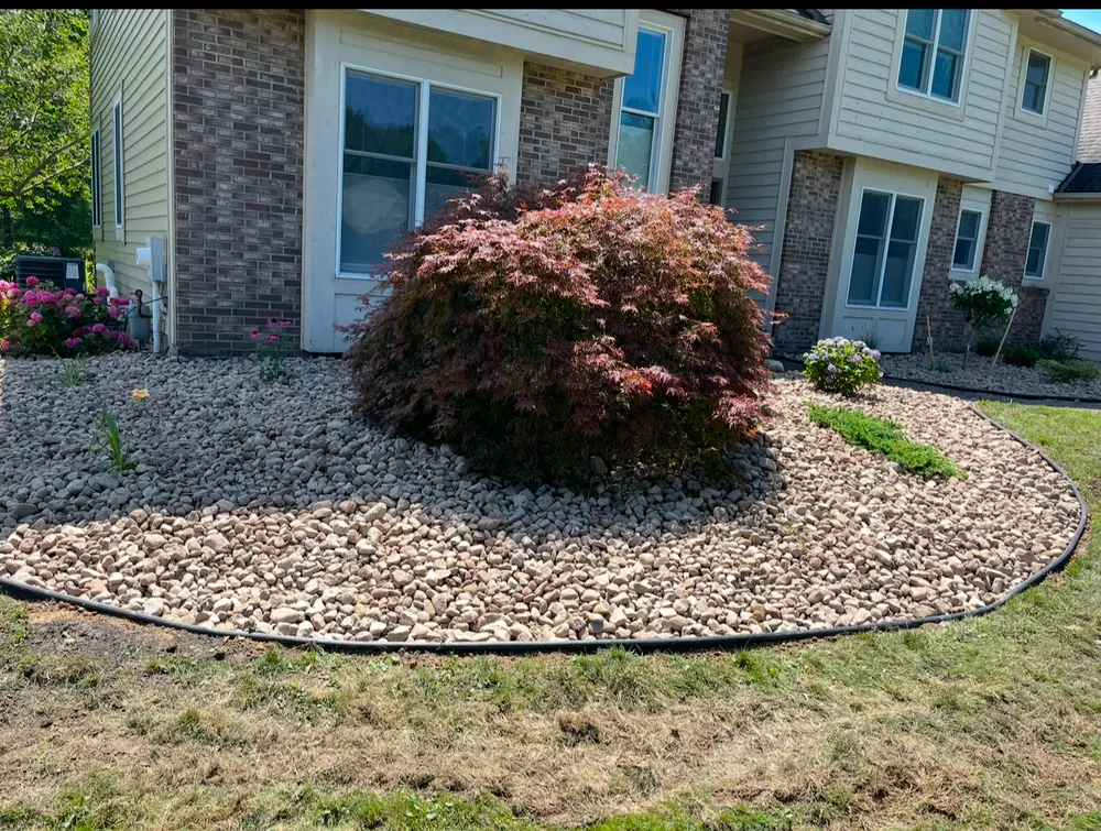 Same bed finished in river rock around the Japanese maple
