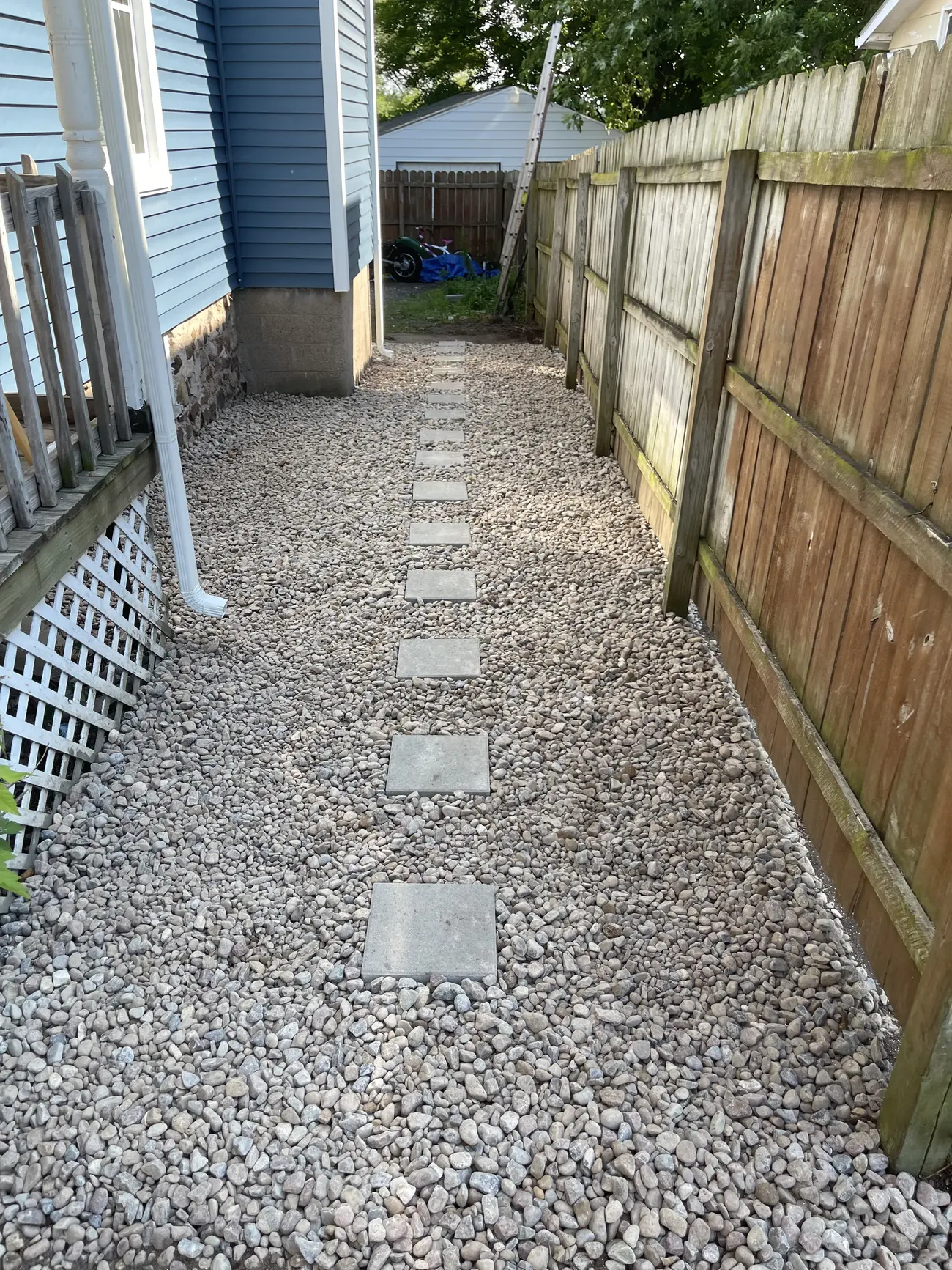 Side yard finished as a decorative stone path with stepping pavers