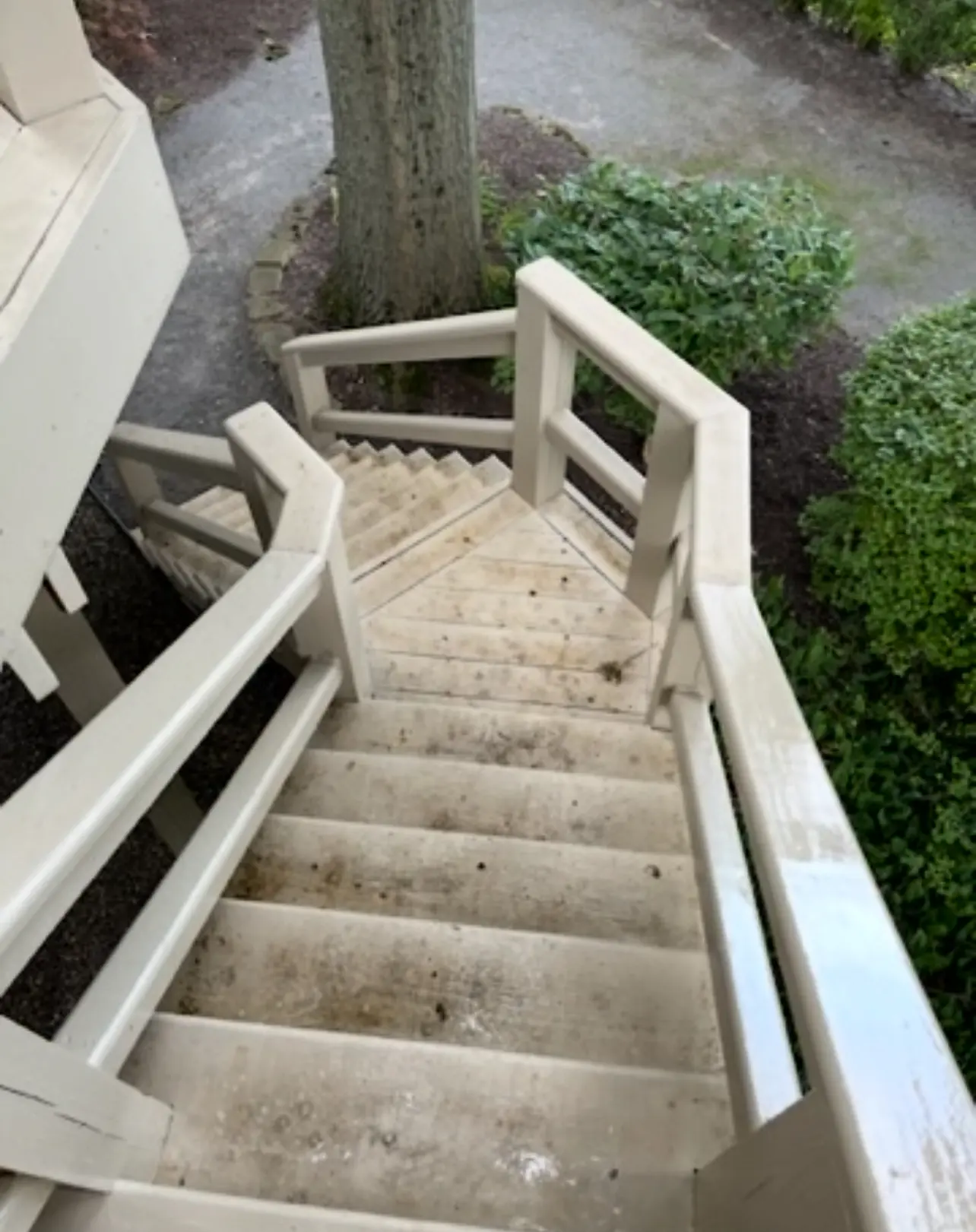 Exterior wood stairway stained with dirt and mildew