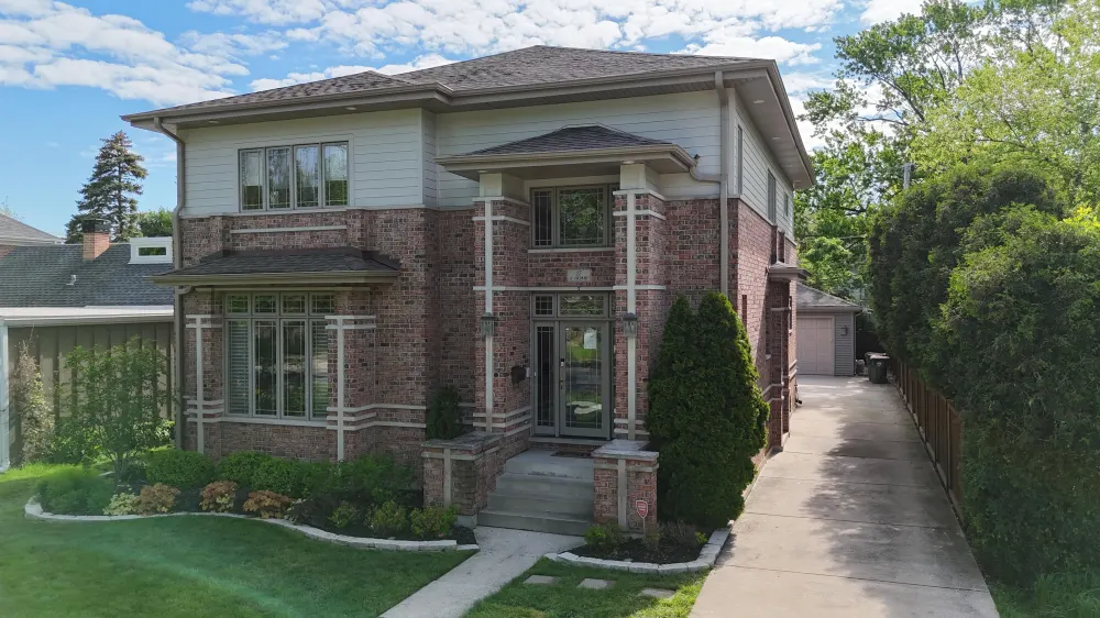 Northwind Exteriors gray roof on brick and siding home