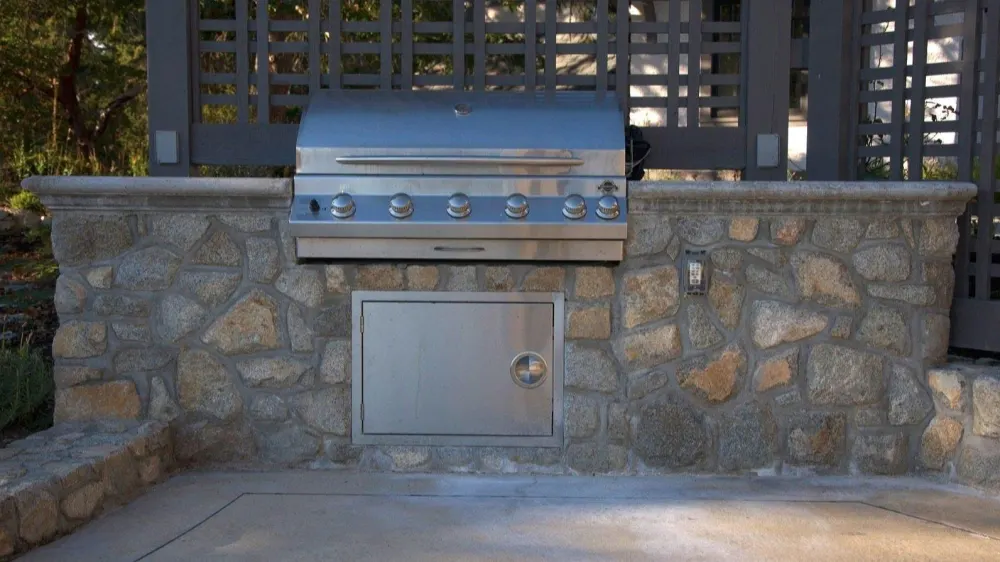 Full stone veneer outdoor kitchen with built in grill