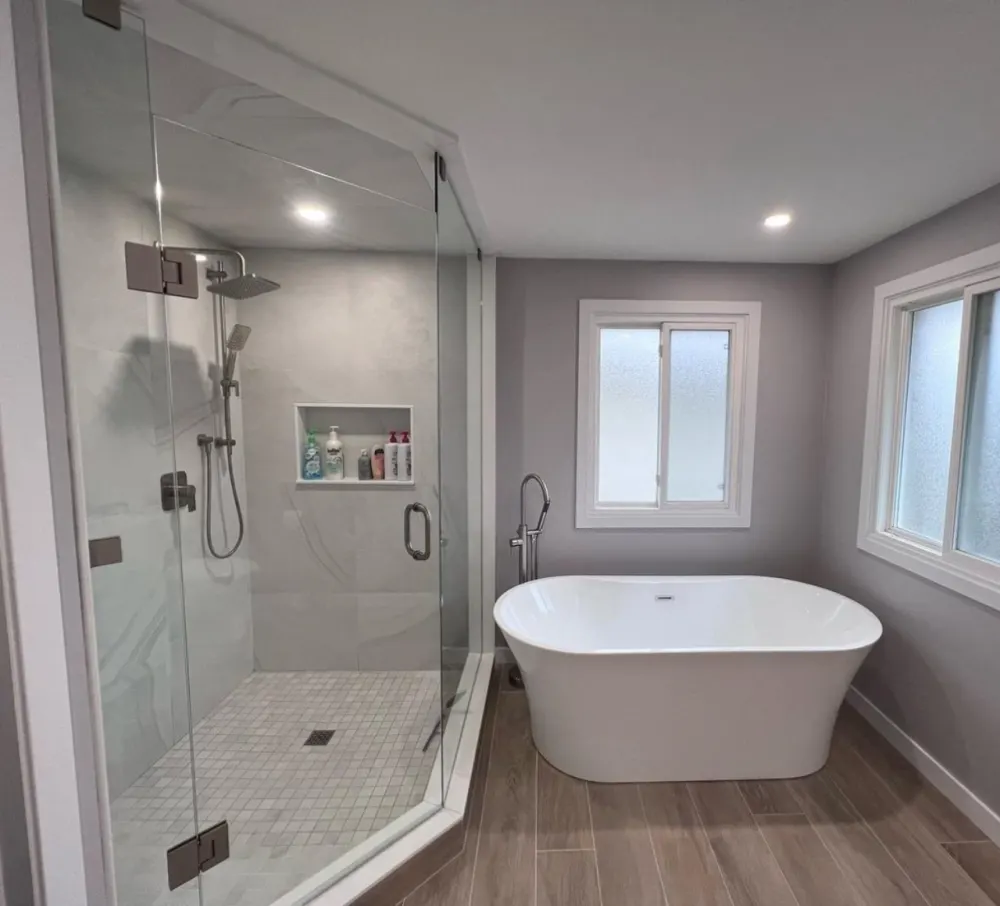 Finished bathroom with a freestanding tub and a glass shower