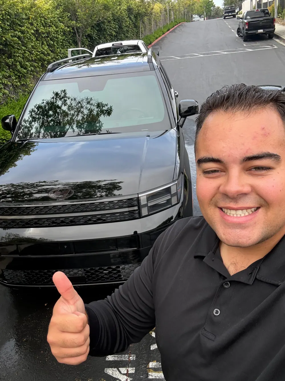 Owner of Stiles Mobile Detailing with a customer vehicle