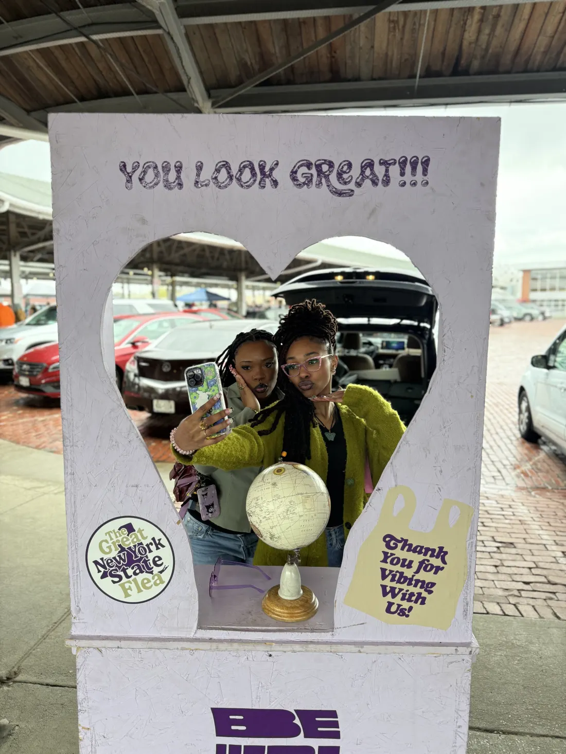 Visitors posing at the heart-shaped photo booth