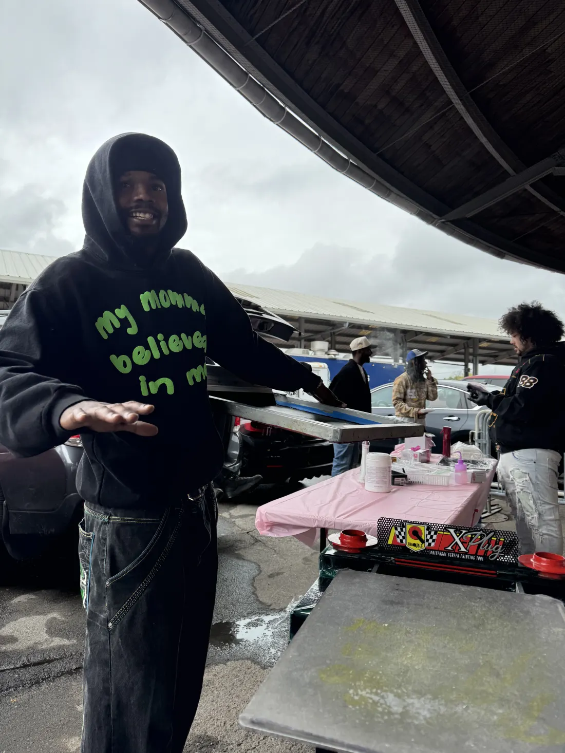 Great NYS Flea vendor standing beside a display