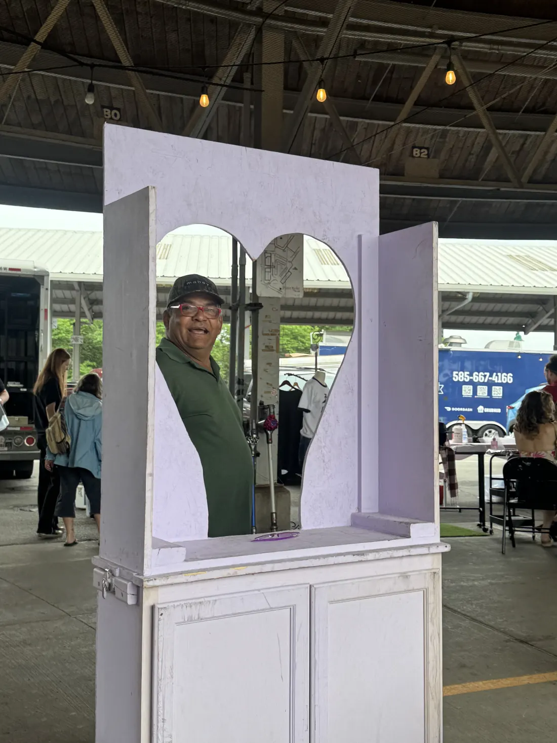 Lavender heart-shaped mirror photo booth at a Great NYS Flea market