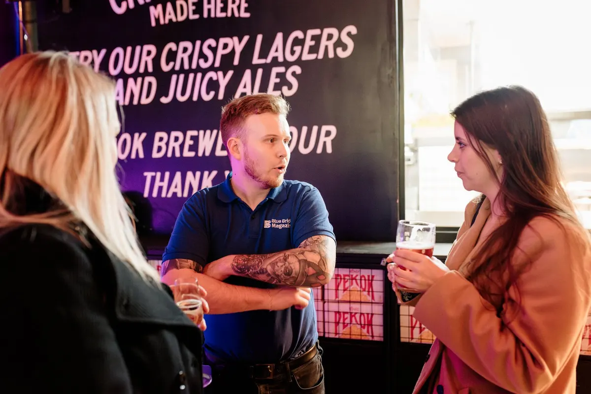 An exhibitor talking with two guests at UK Homes Network LIVE Birmingham