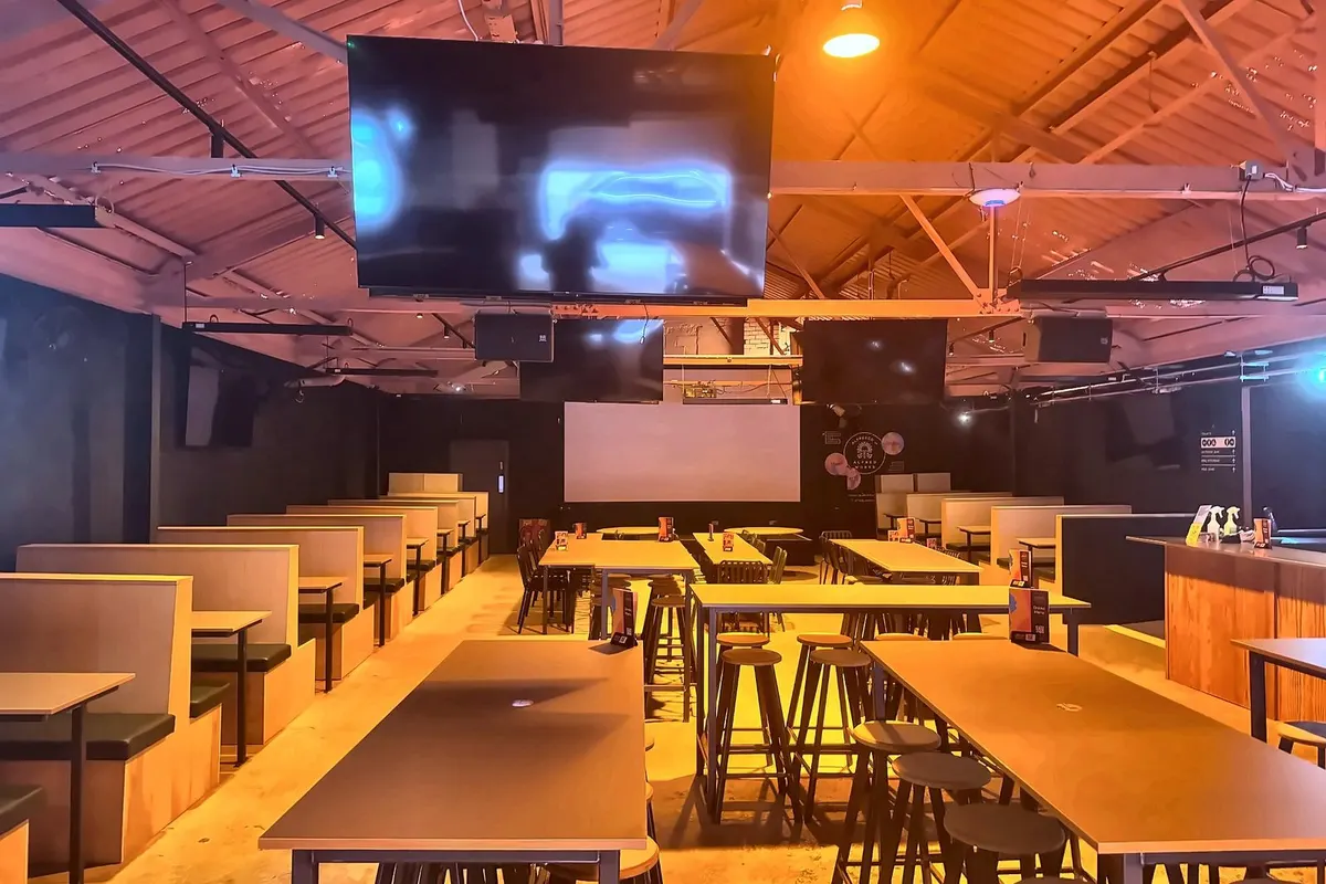 The hall at Alfresco Works, Digbeth, with screens and long tables