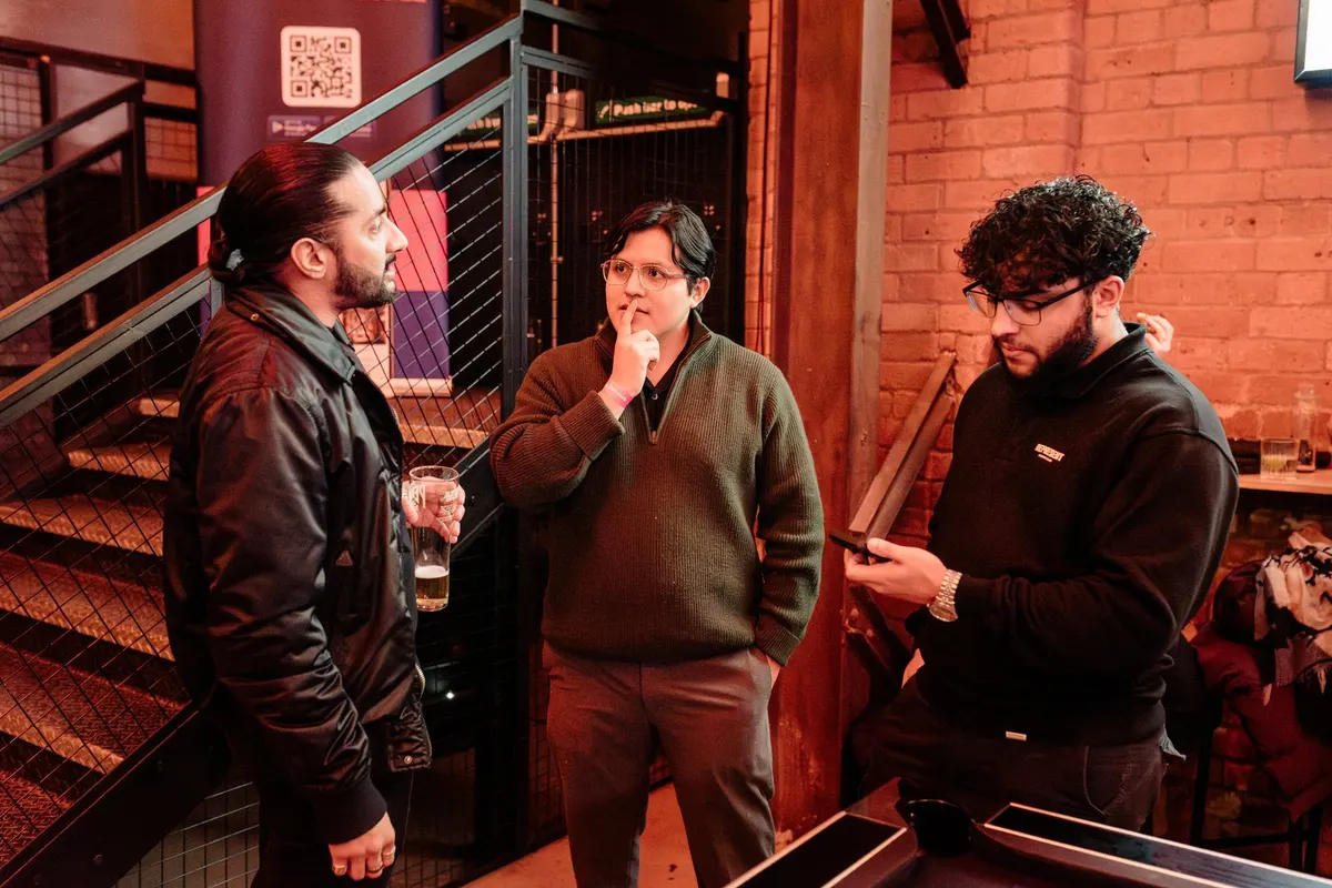 Three guests talking by the stairwell at the Indian Brewery Taproom, Birmingham