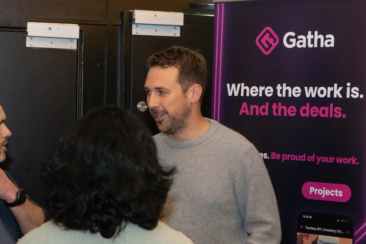 Guests talking by the Gatha banner at UK Homes Network LIVE Leeds