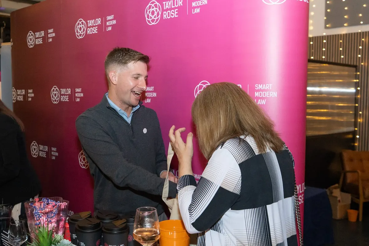 A guest talking with an exhibitor at Archive, Leeds