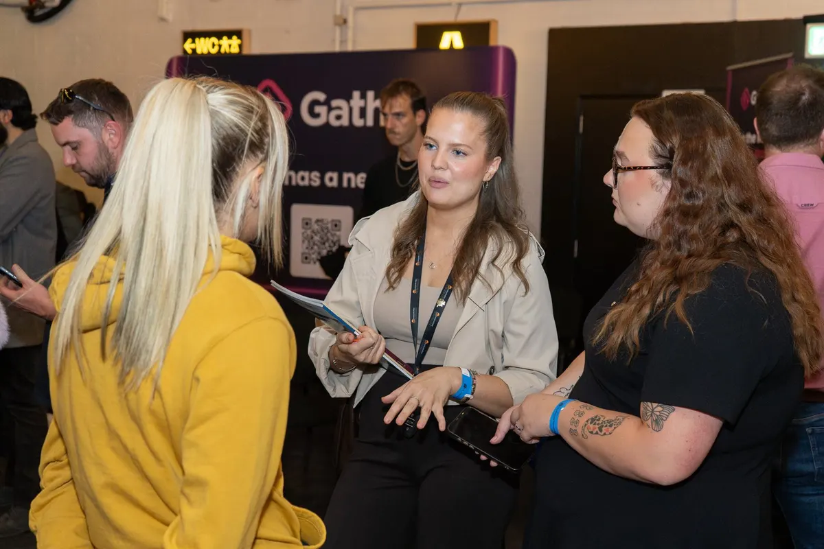 Guests talking in front of the Gatha stand at Archive, Leeds