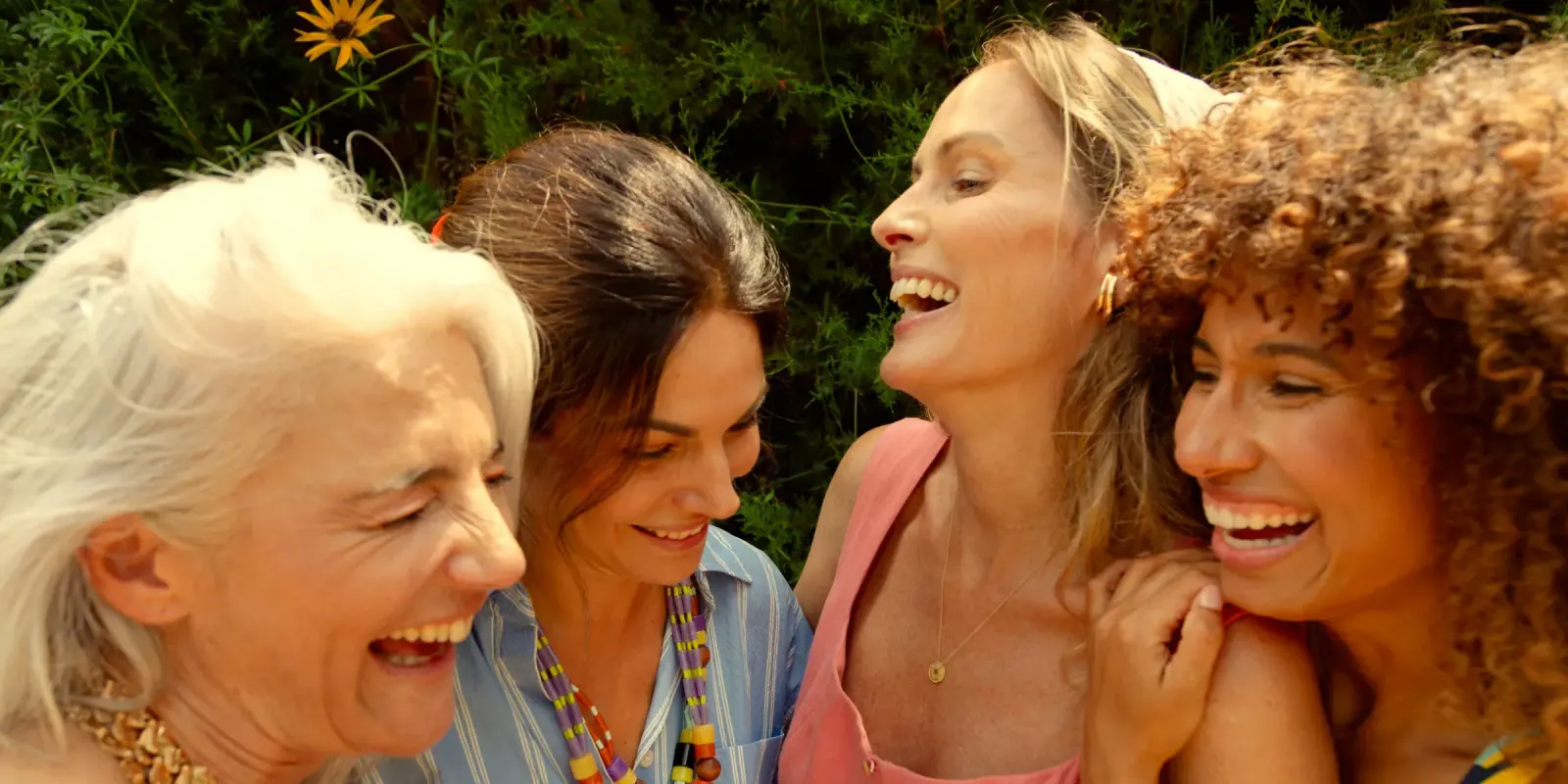 Four women laughing together outdoors, feeling like themselves again with perimenopause and menopause hormone therapy at Lexel in Dunn, NC