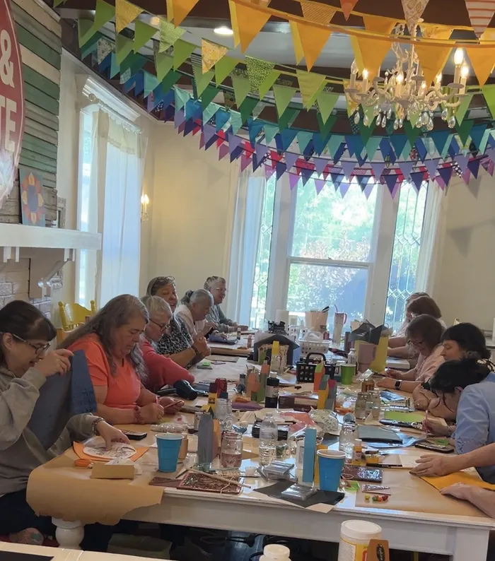 Women creating together at a Ruffled Daisy workshop