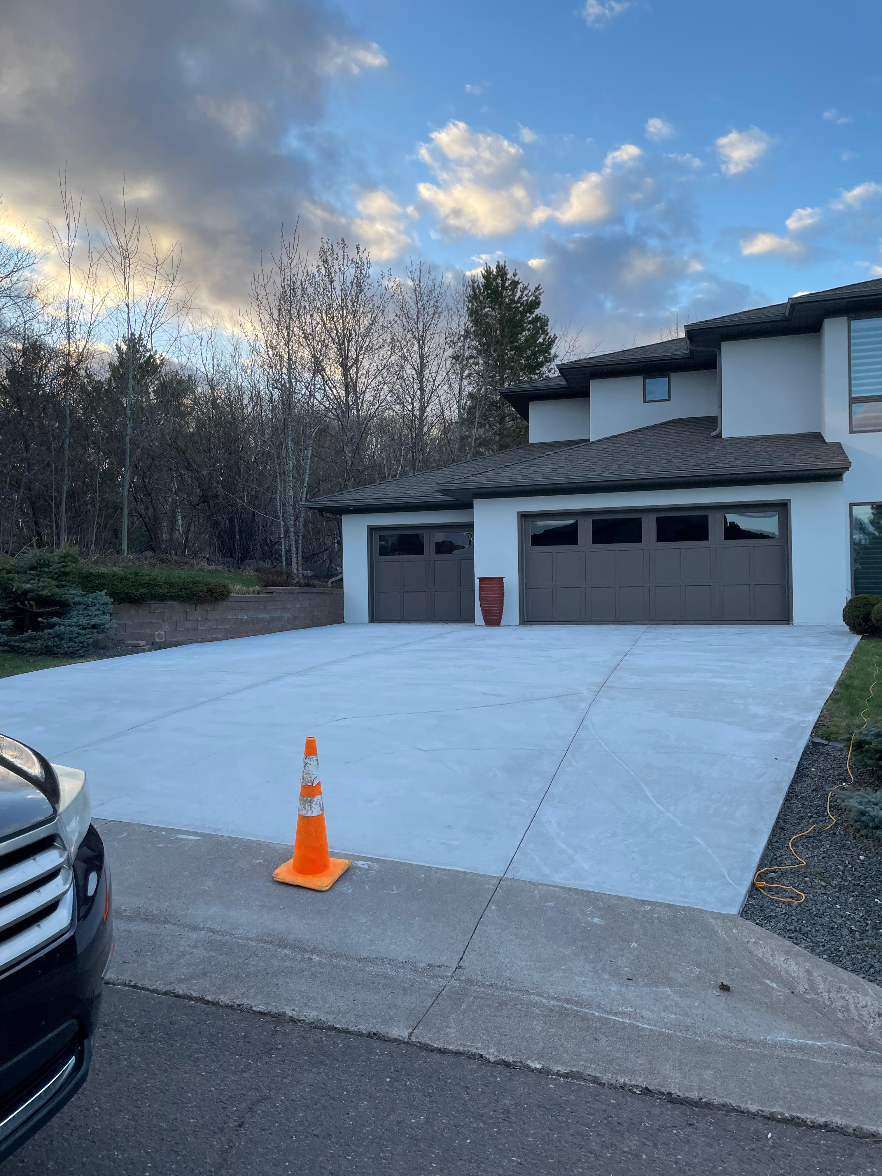 Clean concrete driveway after pressure washing at a home in Duluth, Minnesota
