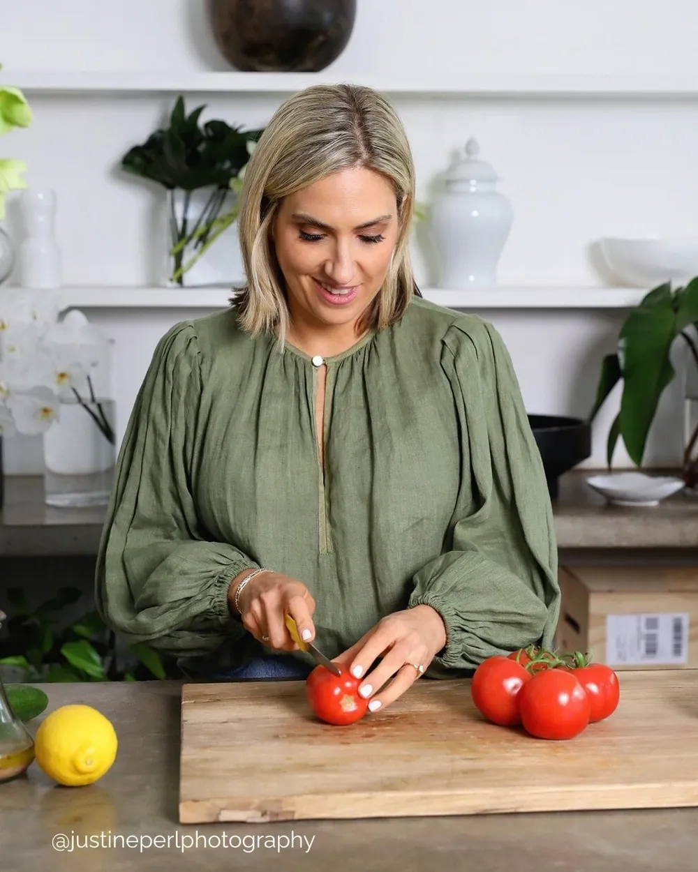 Monique slicing tomatoes in a kitchen