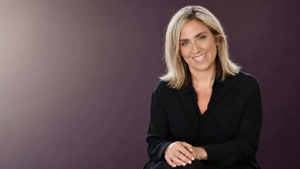 Monique Etkind smiling in a studio portrait