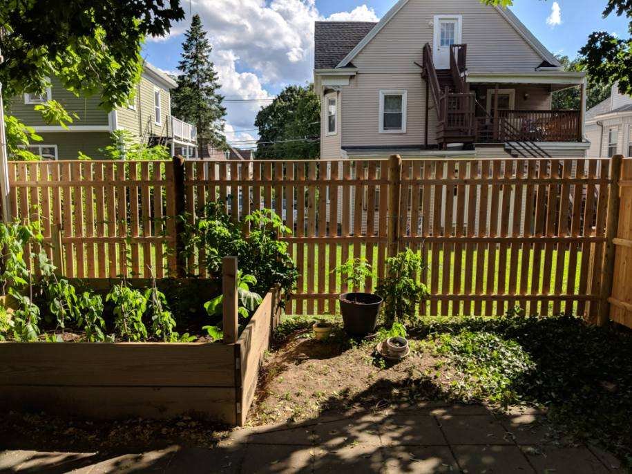 Spaced wood picket fence around a garden by All Fenced In