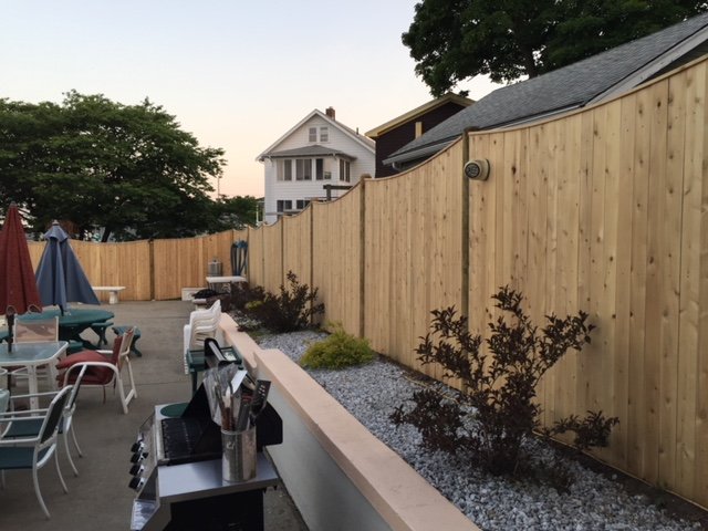 Wood privacy fence around a patio by All Fenced In