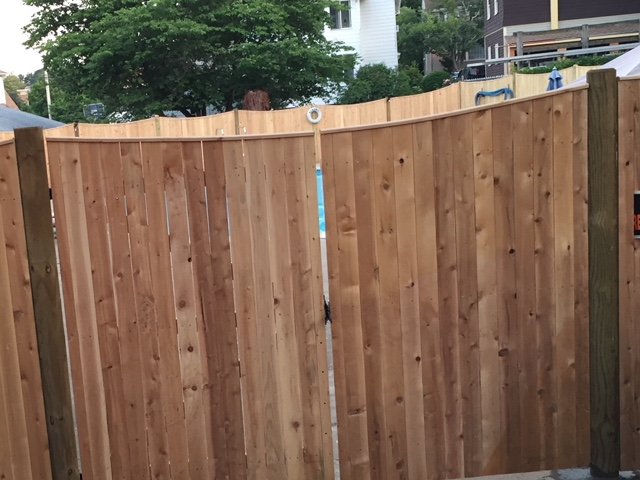 Curved-top wood gate by All Fenced In