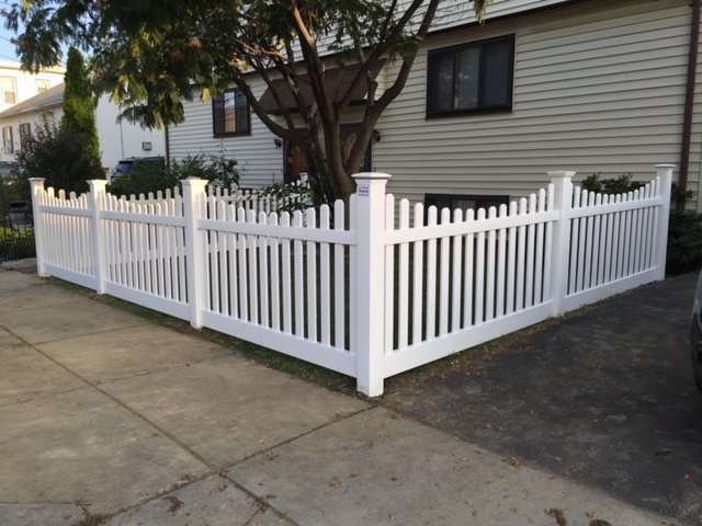 White vinyl picket fence on a corner lot by All Fenced In