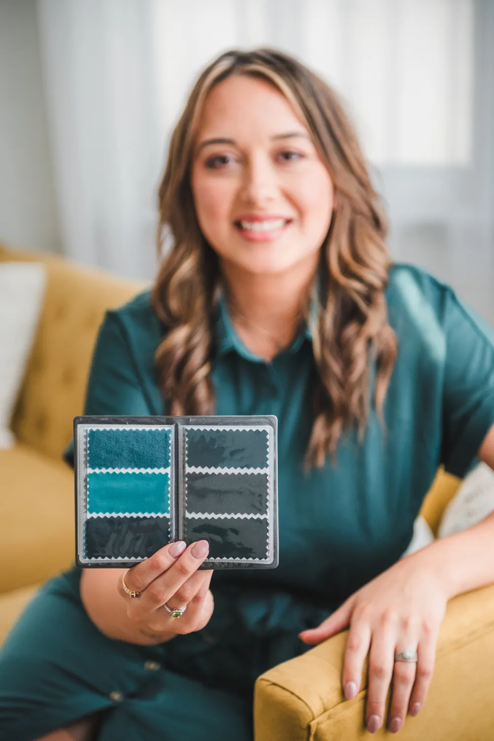 Bethany holding up a physical color wallet of fabric swatches