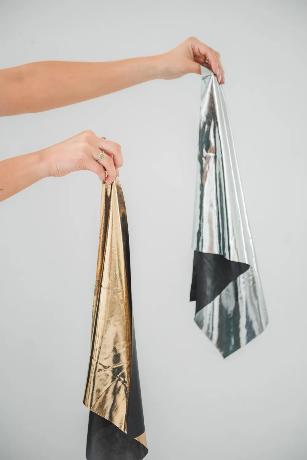 Gold and silver metallic drapes held up side by side