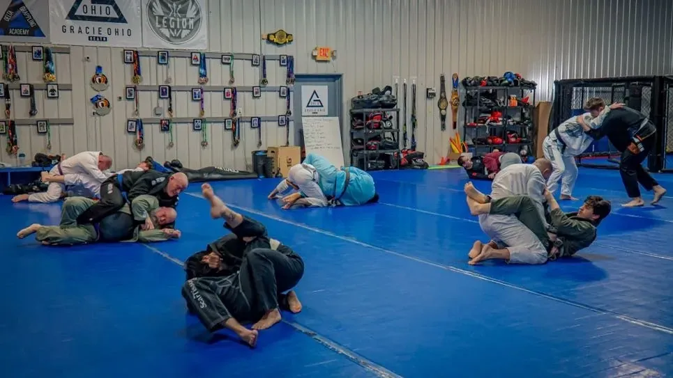 The training floor at Delta with heavy bags, gloves and pads along the wall