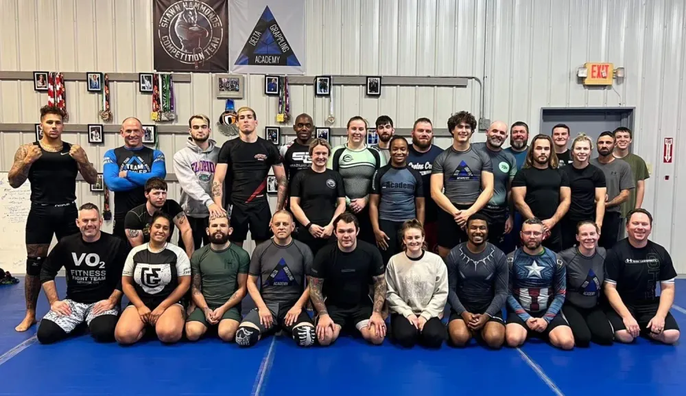 Adults in VO2 Fitness Fight Team and Delta shirts after a training session